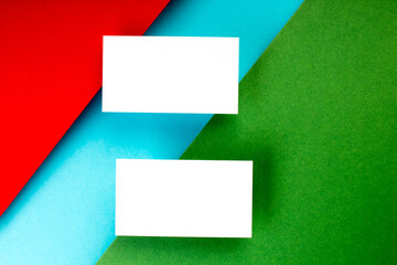 Business card blank over colorful background. Copy space for text. Top view.Business card blank over colorful abstract background. Corporate stationery branding mock-up. Copy space for text. Top view.