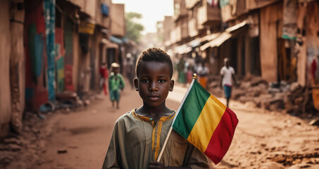 Malian boy holding Mali flag in Bamako street - obrazy, fototapety, plakaty