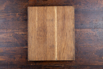Kitchen old cutting board on brown background