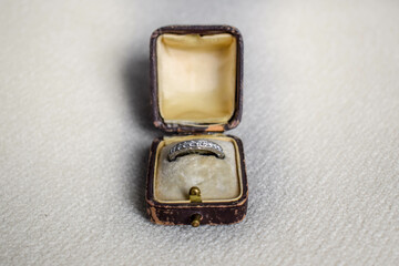 An opened antique / vintage 1920's brown leather ring case lined with yellow velvet and silk, with...