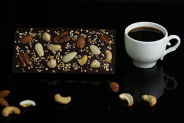 Homemade chocolate with cup of coffee and nuts