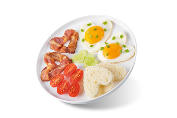 Fresh breakfast with fried eggs, fried bacon slices, bread slices and vegetables in the form of heart for Valentine's day holiday on a white isolated background