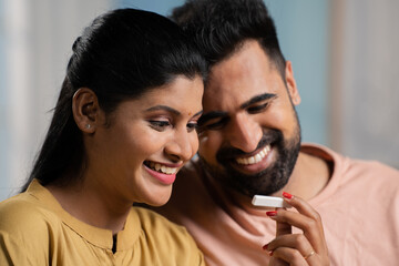 Indian couple got excited after seeing positive pregnancy test result at home - concept of expecting baby, good news and affection