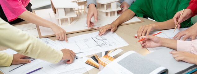 Skilled architect team discuss about house construction while interior designer point an...