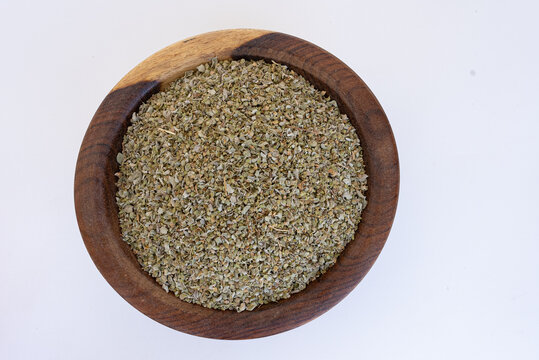 dried oregano on a brown wooden plate on blue marble, pan, close, HD, 24fps