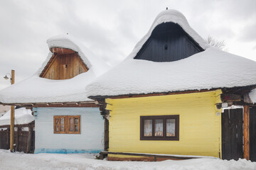 Folk architecture in snowy winter landscape. Vlkolinec village with historical colorfull wooden houses, Slovakia Europe.