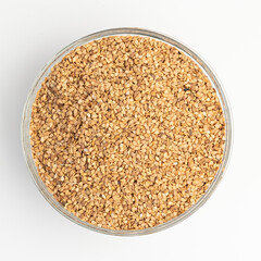 Sesame seeds on  on glass plate isolated on a white background
