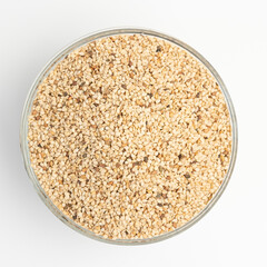 Sesame seeds on  on glass plate isolated on a white background
