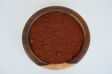 paprika on a wooden plate isolated on a white background
