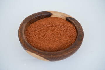 Dry chili peppers on a wooden plate isolated on a white background
