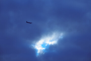flying plane against the background of thunderclouds