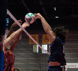 Volleyball players blocking from both sides