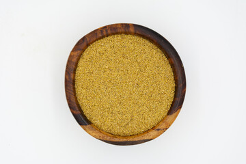 Turmeric powder on a wooden plate isolated on a white background