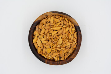 Dried garlic bulbs on a wooden plate on a white background
