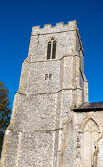 Fototapeta na wymiar Exterior of a rural catholic church tower in sunlight