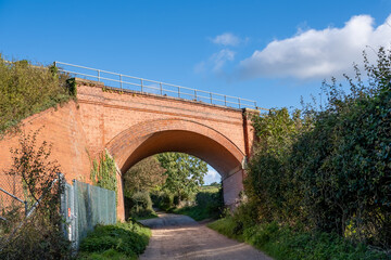 Fototapeta na wymiar Railway bridge in the countryside against a bright blue sky