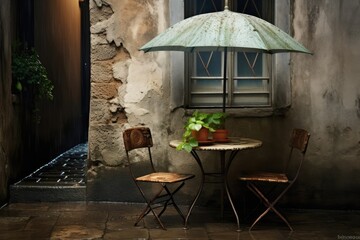 old house with chairs, table, umbrella on the street. 