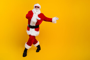 Fototapeta na wymiar Full body portrait of carefree aged santa claus dancing have fun empty space christmas ad isolated on yellow color background
