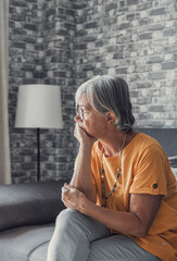 Face of senior caucasian hoary woman looking away deep in sad thoughts feels lonely close up portrait, recollect memories and life moments, depressed grandmother alone indoors, yearning for husband  - obrazy, fototapety, plakaty