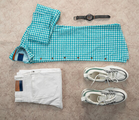 Match a blue check shirt with white pants and white shoes
