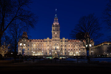 Fototapeta premium The lighted 1886 Second Empire style Parliament Building seen during an early blue hour winter morning, Quebec City, Quebec, Canada