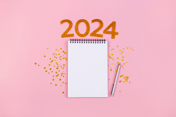 New Year empty goals, plans 2024 concept with notebook and pen. flat lay style. Christmas planning concept with empty space