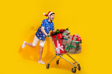 Full size portrait of cheerful crazy person push market trolley pile stack giftbox empty space...
