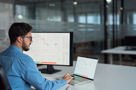Business man trader broker analyst investor using computer analyzing stock trade crypto market investing finances in stockmarket working in dark office. Copy space for learning trading course ads.