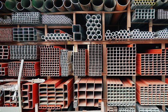 Series of different sizes of metal pipes on the shelf at market in Asia.