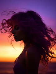 Naklejka premium backlit portrait, silhouette of a female model against a vibrant sunset