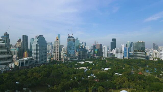 Aerial view city office building with green park Lumpini morning sunrise Bangkok Thailand