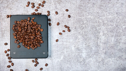 Medium roasted arabica beans on coffee scales, top view, space for text on the right, background...