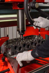 A master repairs an engine on a machine