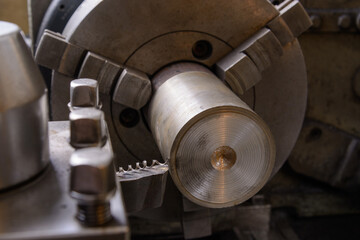 An old lathe at work. Processing the workpiece with a cutter