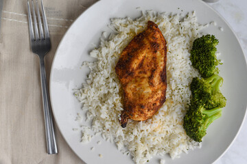 seasoned chicken breast  with white rice and broccoli