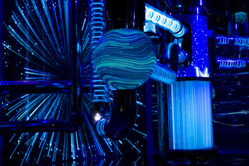 Blue glow of a demonstration of a scientific model of a nuclear reactor. Pipes and water tanks for...