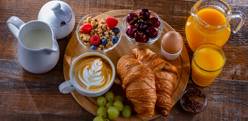 Breakfast served with coffee, juice, egg, cereals and croissants