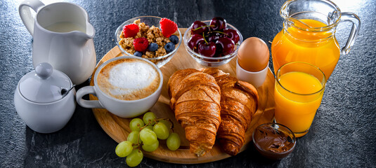 Breakfast served with coffee, juice, egg, cereals and croissants