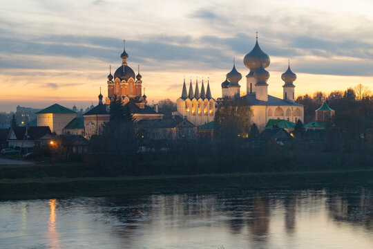 Tikhvinka River and the ancient Tikhvin Assumption  Monastery in October cloudy sunset. Leningrad region, Russia