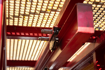 The lifting hoist and pulley reel equipment on balance beam that using to lift and move the heavy weight object at the factory. Industrial equipment and machinery part, selective focus.