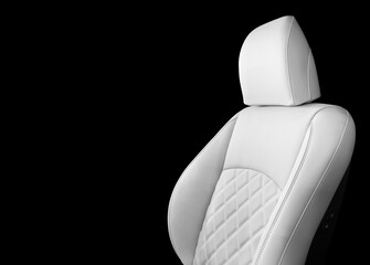 Luxury white leather interior. Part of white leather car seat details with stitching isolated on...