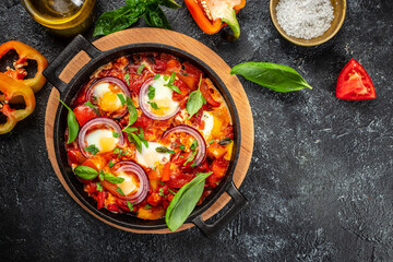 Healthy Shakshuka. Fried eggs, tomatoes, bell pepper, vegetables and herbs. Middle eastern traditional dish