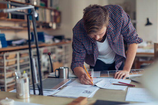 Male artist doing home interior design in the office