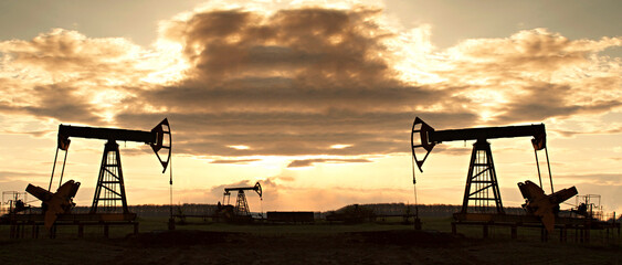 Oil rig at sunset the sun. Silhouette of Pump Jack are running. - 683883143