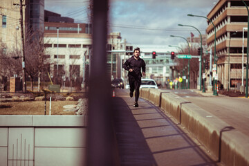 Man Jogging on a City Bridge