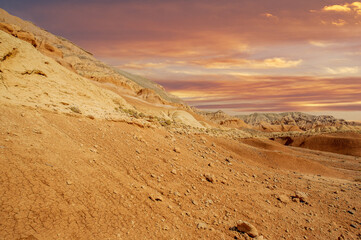 Enjoy a breathtaking sunset over the Red Boguty Mountains. Journey into the stunning desert...