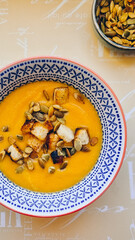pumpkin puree soup with grains and crackers, without people