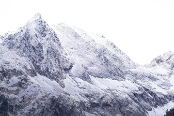 Fototapeta na wymiar Rocky snow capped mountain called Néouvielle massif en Hautes Pyrenees, France.