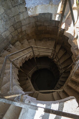Fototapeta premium Creepy dusty hexagonal stairs on an abandoned building