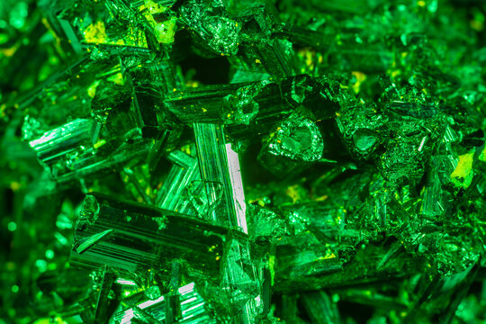 Green crystal mineral stone. Gems. Mineral crystals in the natural environment. Texture of precious and semiprecious stones. Seamless background with copy space colored shiny surface of precious stone